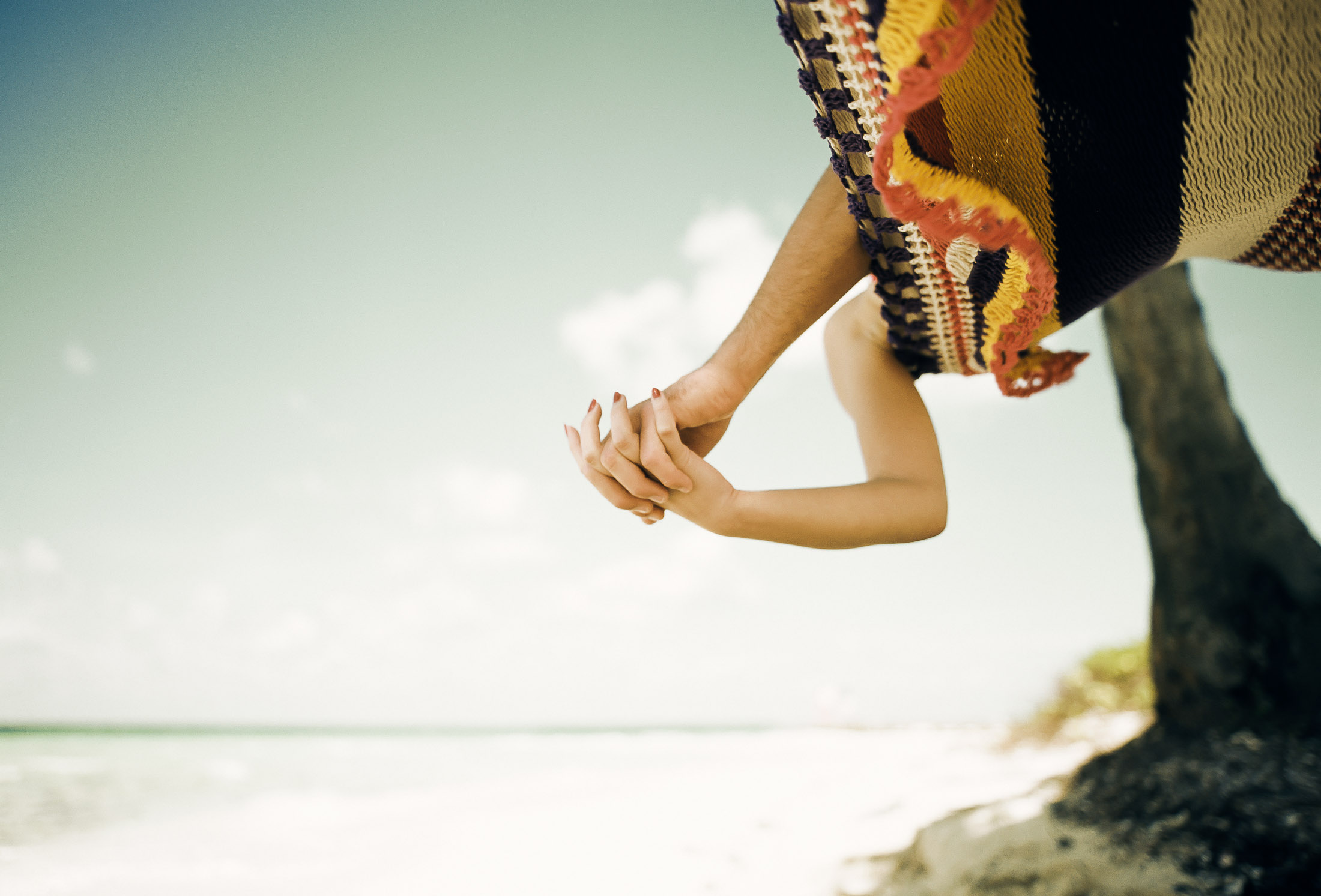 Hands intertwined on beach